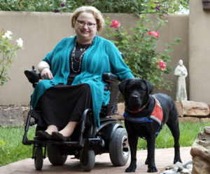 Marcie Davis posing with her dog, Lovey.